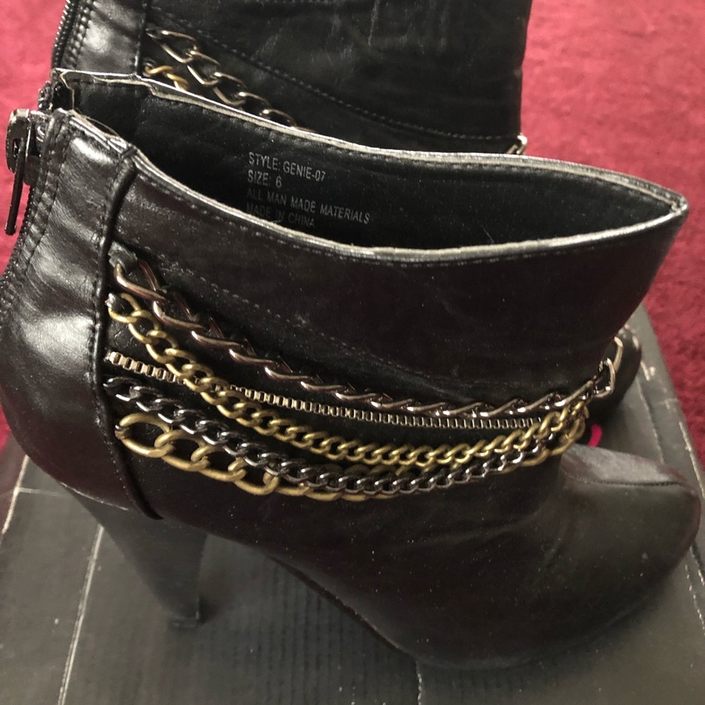 Twisted black boots with gold and silver chains